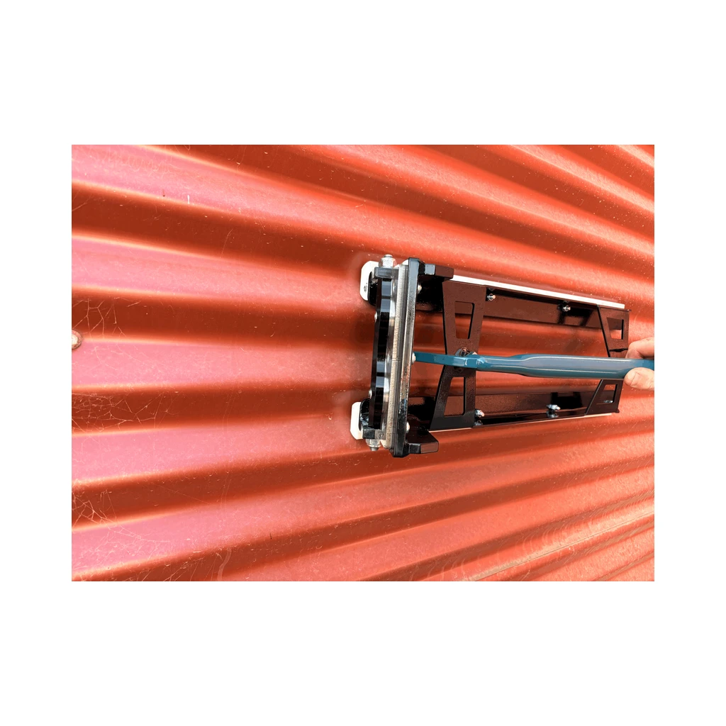 EERA corrugated notcher held against a red corrugated wall